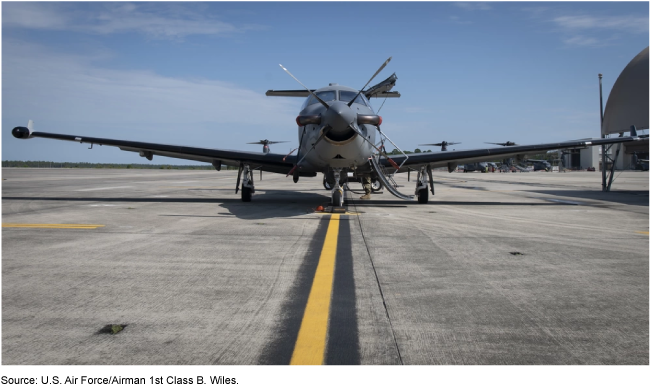 U-28 plane on a runway with a blue sky in the background.